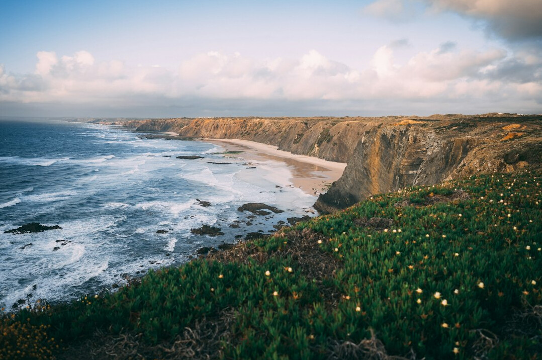 Rugged coastal landscape in Portugal under a cloudy sky