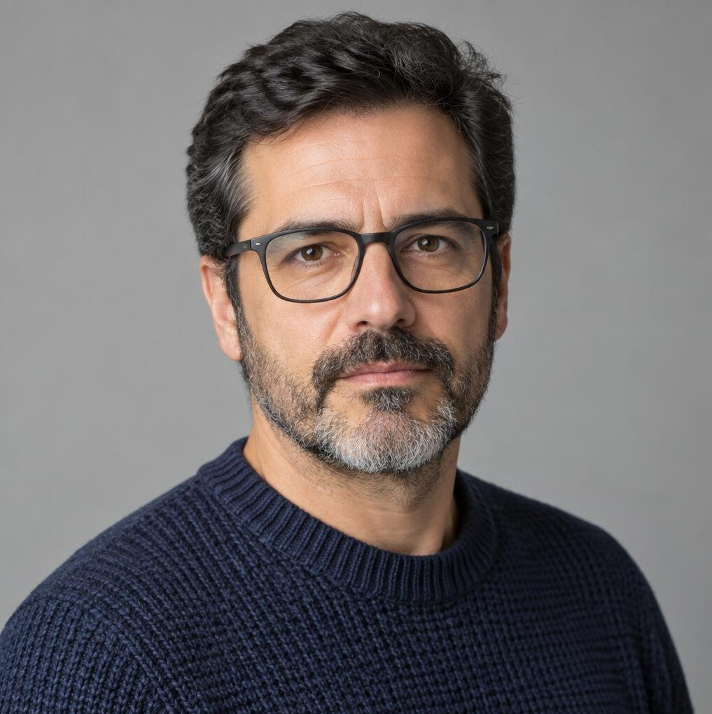Studio portrait of a Portuguese man with glasses and a beard