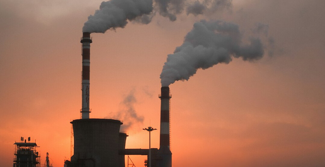 Industrial factory with smoke stacks at dusk